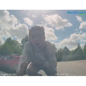 Angry man climbs on hood